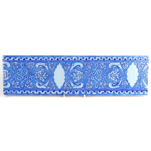 376 - Turkish Ottoman Baba Makkas Iznik pottery tile hand painted with stylised flowers, 40cm x 11cm