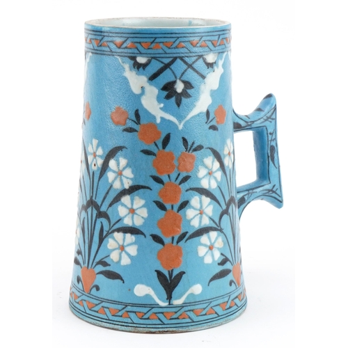 153 - Turkish Ottoman Iznik pottery tapering water vessel hand painted with flowers, 20cm high