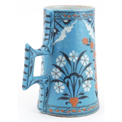 153 - Turkish Ottoman Iznik pottery tapering water vessel hand painted with flowers, 20cm high