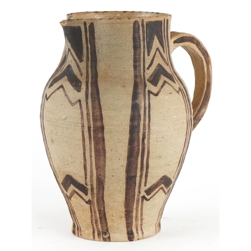 318 - Early Carter's Poole studio pottery jug hand painted with geometric design, 15.5cm high