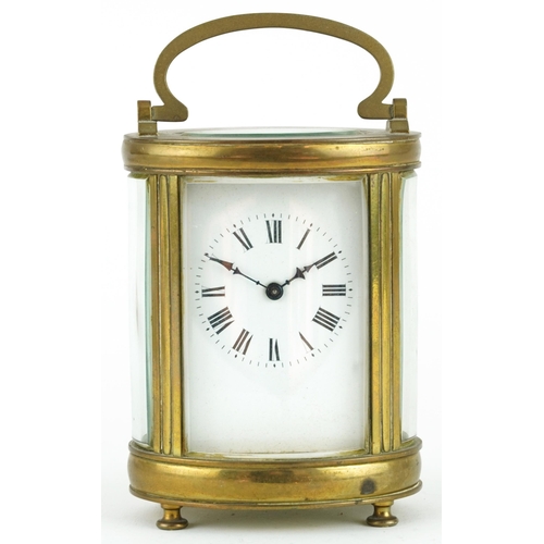 135 - 19th century oval brass cased carriage clock with enamelled dial having Roman numerals, 11.5cm high ... 