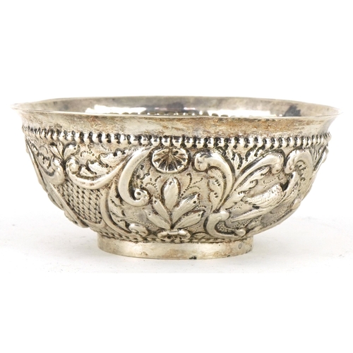 465 - Asian circular silver footed bowl embossed with birds amongst flowers and foliage, possibly Thai, 13... 