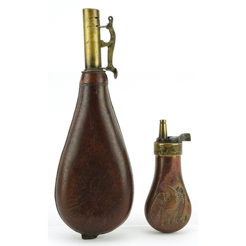 2473 - Two antique brass mounted powder flasks including one with copper body embossed with an eagle, the l... 