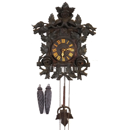 132 - German Black Forest cuckoo clock with weights and pendulum carved with flowers and foliage, the cloc... 