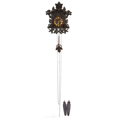 132 - German Black Forest cuckoo clock with weights and pendulum carved with flowers and foliage, the cloc... 