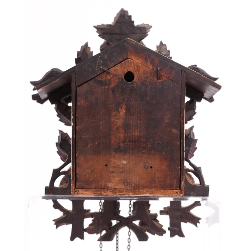 132 - German Black Forest cuckoo clock with weights and pendulum carved with flowers and foliage, the cloc... 