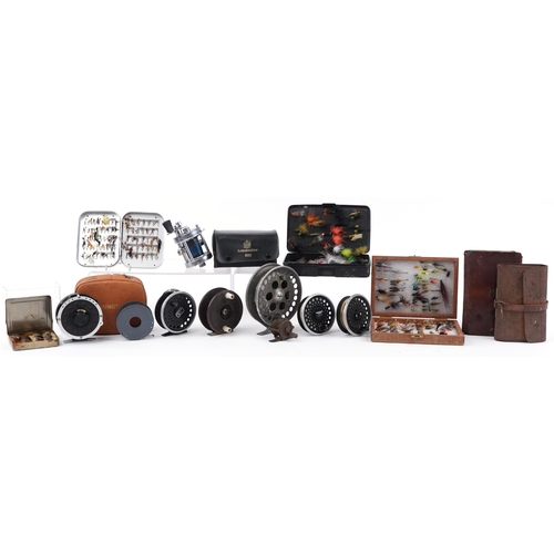 299 - Assorted fly fishing reels and vintage leather cased flies, the largest 12cm in diameter