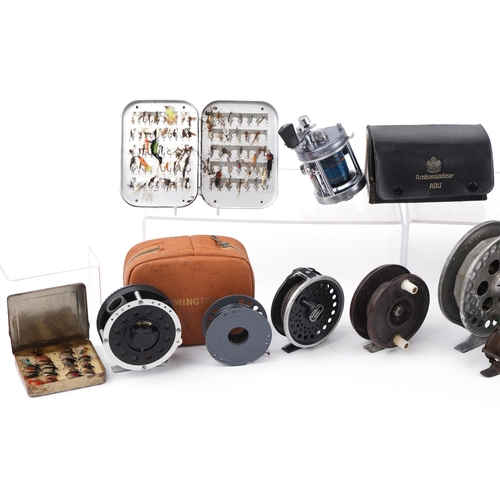 299 - Assorted fly fishing reels and vintage leather cased flies, the largest 12cm in diameter