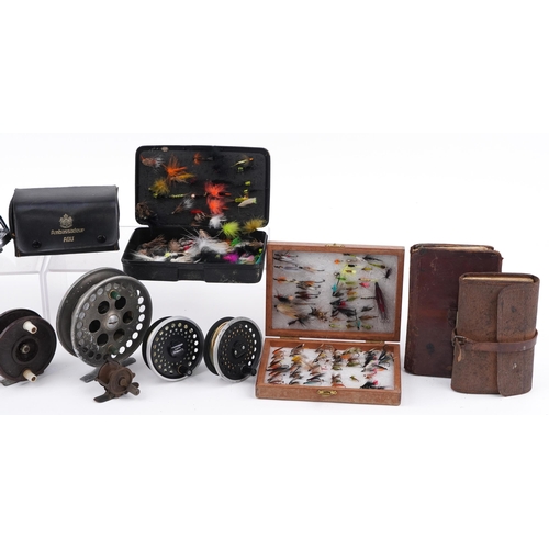 299 - Assorted fly fishing reels and vintage leather cased flies, the largest 12cm in diameter