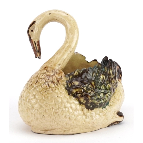 344 - 19th century slipware style cache pot in the form of a swan with a fish, 18cm wide