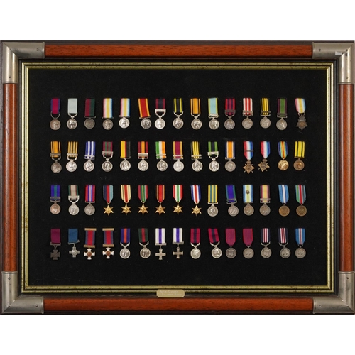 2408 - Decorative military interest mahogany framed display of British campaign and gallantry medals, overa... 