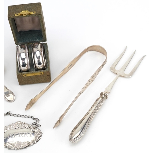 191 - Georgian and later silver objects including two caddy spoons, sugar tongs, sherry decanter label, a ... 