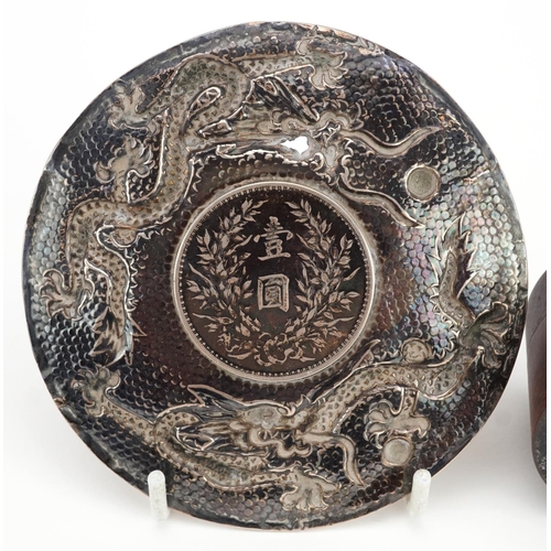 179 - Chinese unmarked silver dragon dish inset with a Fat Man dollar and a hardwood cylindrical box inset... 