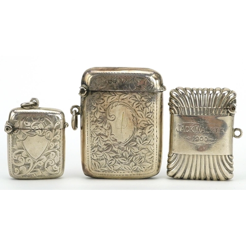 337 - Three Edwardian and later silver vestas including one fluted and two with engraved decoration, the l... 