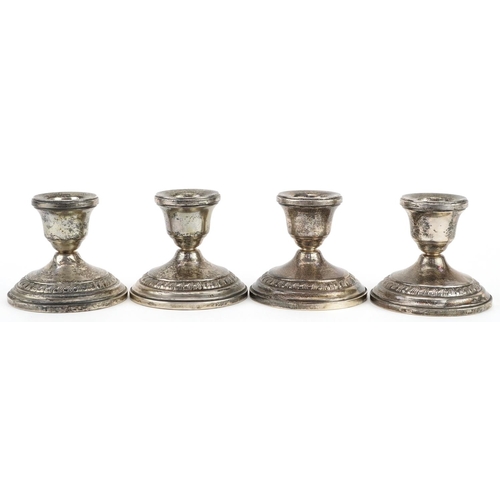 334 - Columbia, set of four circular sterling silver  weighted dwarf candlesticks, 8cm in diameter, total ... 