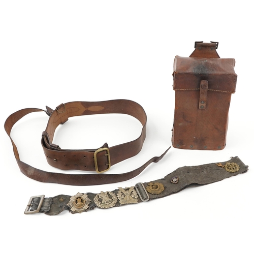 2434 - Militaria including brown leather Sam Browne and canvas belt with various cap badges including Tynes... 