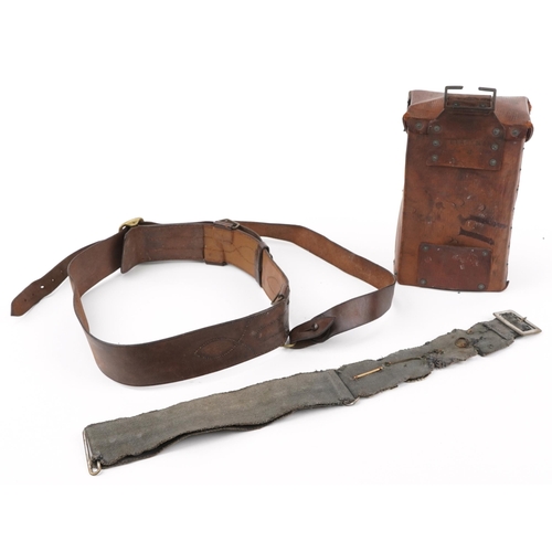 2434 - Militaria including brown leather Sam Browne and canvas belt with various cap badges including Tynes... 