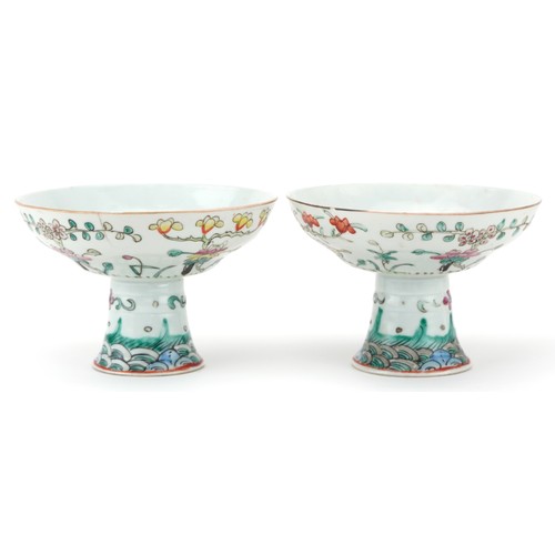 316 - Pair of Chinese porcelain stem bowls hand painted in the famille rose palette with flowers, each 14c... 