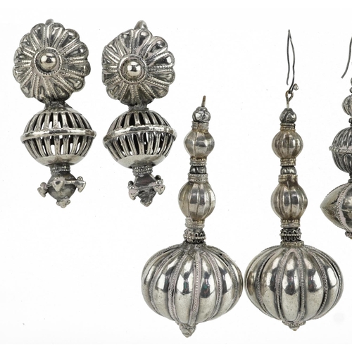 252 - Four pairs of Indian unmarked silver and white metal earrings including filigree and pierced example... 