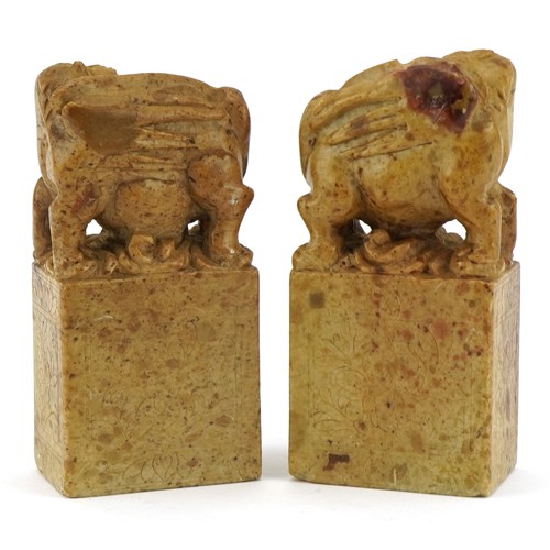 2317 - Pair of Chinese soapstone figures carved with mythical animals and flowers, each 12cm high