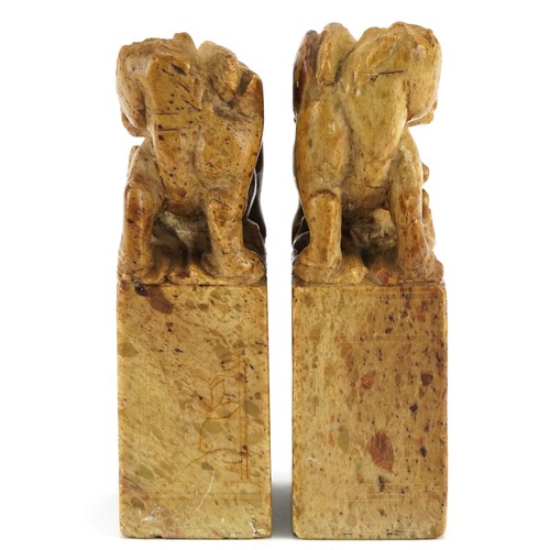 2317 - Pair of Chinese soapstone figures carved with mythical animals and flowers, each 12cm high