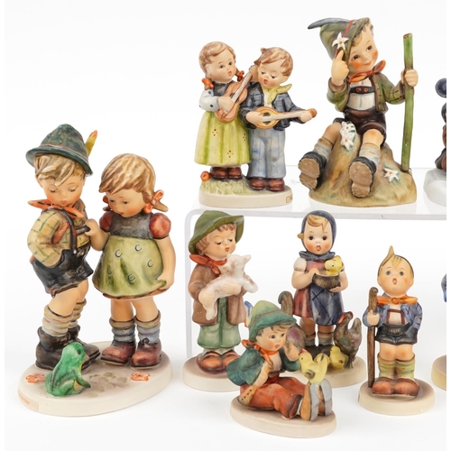 657 - Eleven Goebel Hummel hand painted figures including Holiday Surprise and Making Spirits Bright, the ... 