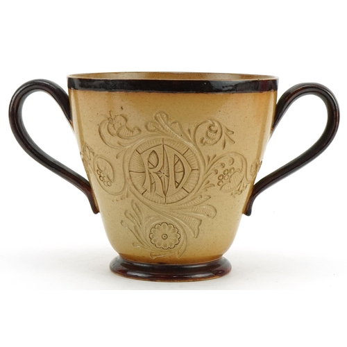 408 - Mark Marshall for Doulton Lambeth, stoneware twin handled loving cup with incised motto When drink i... 