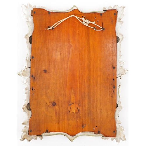 523 - 19th century German floral encrusted porcelain wall mirror with bevelled glass, 44cm x 33cm