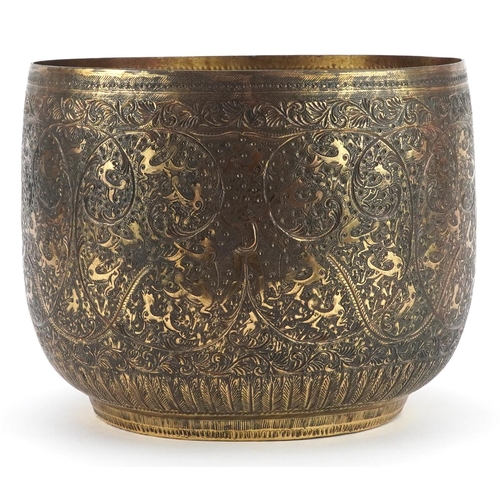 230 - Indian brass jardiniere engraved with mythical animals amongst flowers, 20cm high x 25cm in diameter