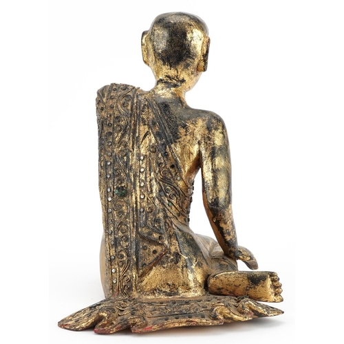 221 - Thai gilt carved wood seated figure of a robed monk, 31cm high