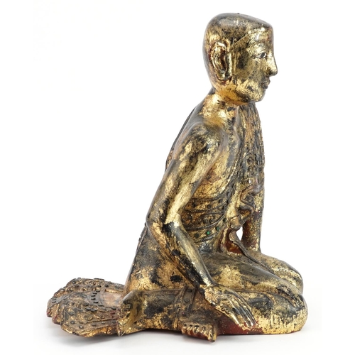 221 - Thai gilt carved wood seated figure of a robed monk, 31cm high