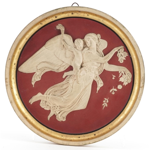 524 - Peter Ipsen, Danish terracotta circular wall plaque decorated in relief with an angel and Putti, imp... 