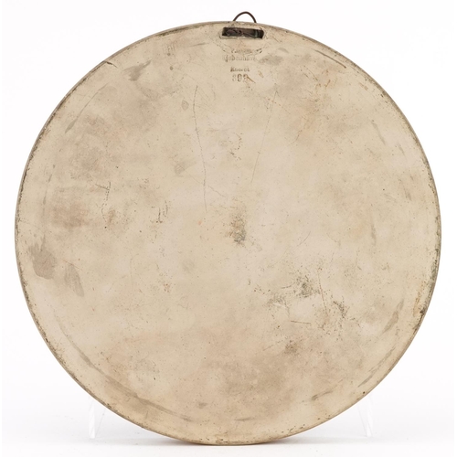 524 - Peter Ipsen, Danish terracotta circular wall plaque decorated in relief with an angel and Putti, imp... 