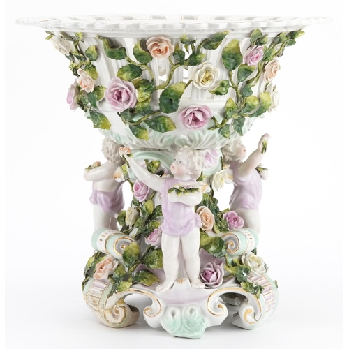 252 - 19th century German floral encrusted porcelain centrepiece surmounted with three Putti, 30cm high x ... 