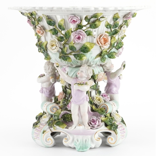 252 - 19th century German floral encrusted porcelain centrepiece surmounted with three Putti, 30cm high x ... 