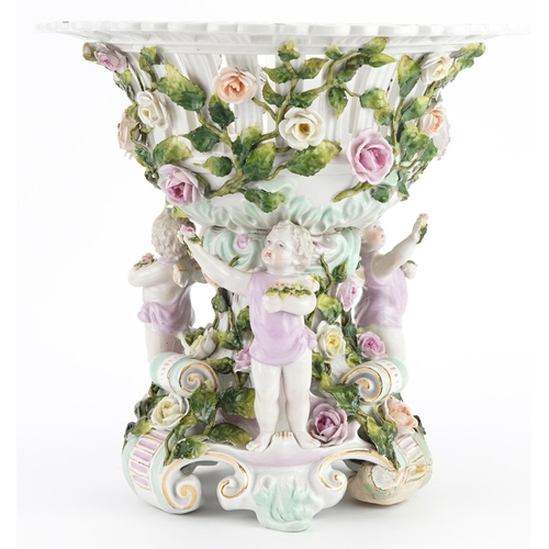 252 - 19th century German floral encrusted porcelain centrepiece surmounted with three Putti, 30cm high x ... 