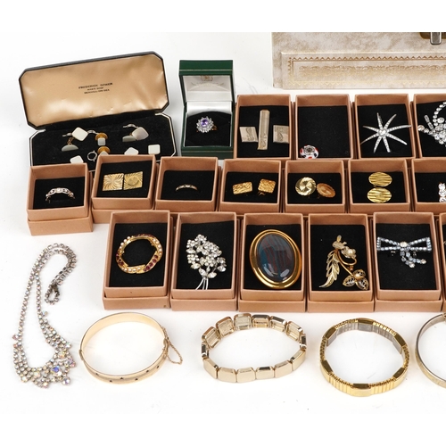 3819 - Large collection of costume jewellery including brooches, bracelets and cufflinks, some housed in a ... 