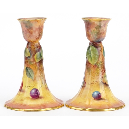 162 - Paul English for Royal Worcester, pair of porcelain candlesticks hand painted with fruit, each 12cm ... 