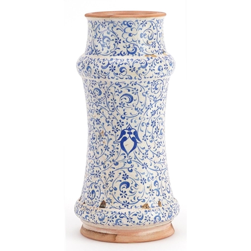 430 - Islamic pottery albarello jar hand painted with stylised flowers, 26cm high