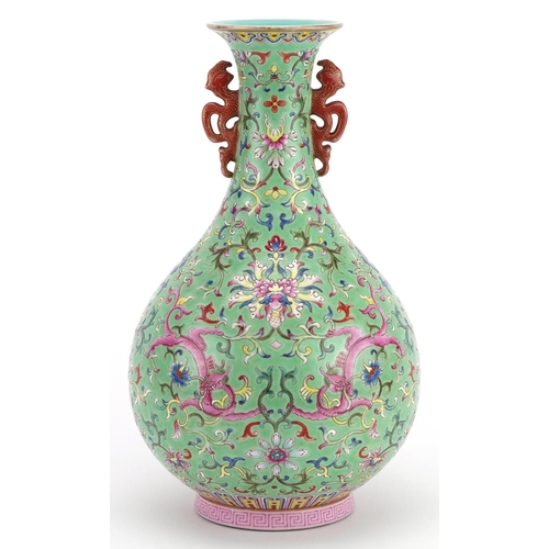 19 - Chinese porcelain green ground vase with iron red handles hand painted in the famille rose palette w... 