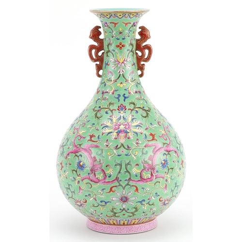 19 - Chinese porcelain green ground vase with iron red handles hand painted in the famille rose palette w... 