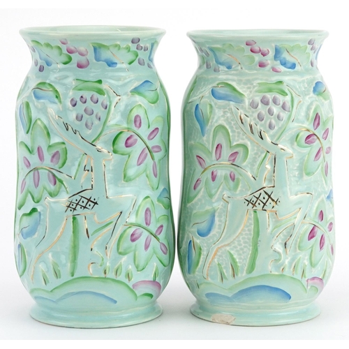 409 - Crown Devon, pair of Art Deco vases hand painted and decorated in low relief with leaping deer among... 