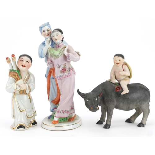 494 - Three Chinese porcelain figures including one of a nude box on water buffalo and a Chinese Revolutio... 