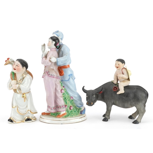 494 - Three Chinese porcelain figures including one of a nude box on water buffalo and a Chinese Revolutio... 