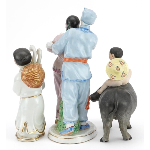 494 - Three Chinese porcelain figures including one of a nude box on water buffalo and a Chinese Revolutio... 