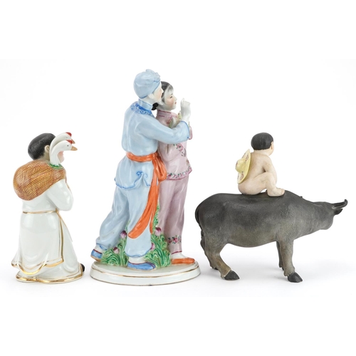 494 - Three Chinese porcelain figures including one of a nude box on water buffalo and a Chinese Revolutio... 