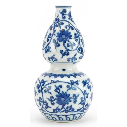 24 - Chinese blue and white porcelain double gourd vase hand painted with flower heads amongst scrolling ... 