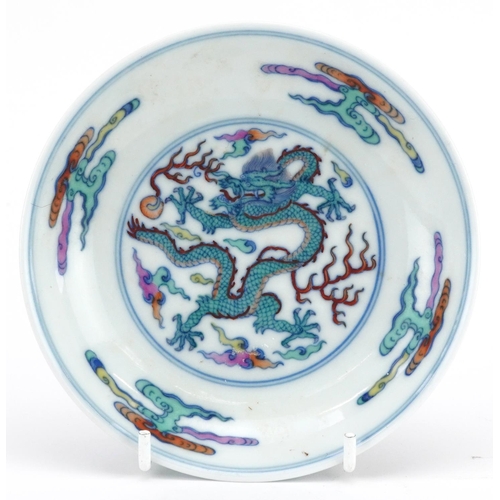 446 - Chinese doucai porcelain dish hand painted with a dragon chasing the flaming pearl amongst clouds, s... 