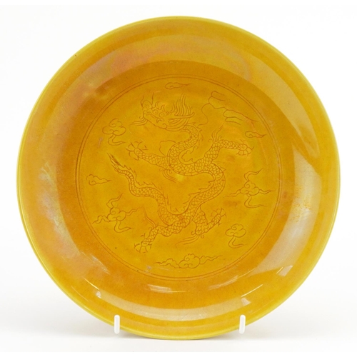 498 - Chinese porcelain yellow ground shallow dish incised under glaze with a dragon amongst clouds, six f... 
