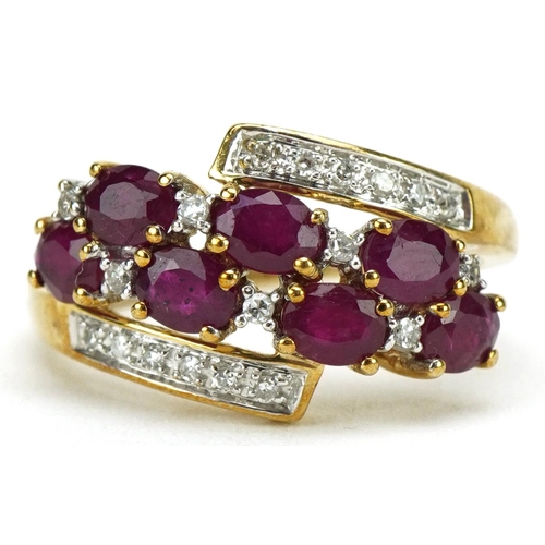 3185 - 9ct gold ruby and diamond crossover cluster ring, total diamond weight approximately 0.18 carat, tot... 